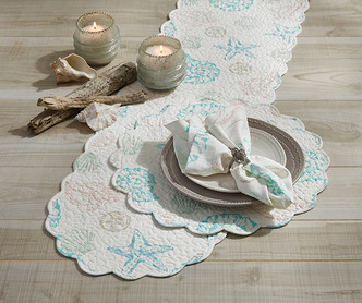 Shell Finders Round Quilted Placemats - Set of Four on table with runner and napkins