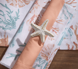 White Starfish Metal Napkin Rings - Set of Four on table