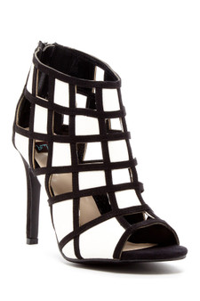 Black and white cage-style stiletto heels with a geometric grid pattern and peep-toe design.