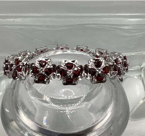 A garnet with rhinestones link bracelet featuring repeating red garnet flower clusters.