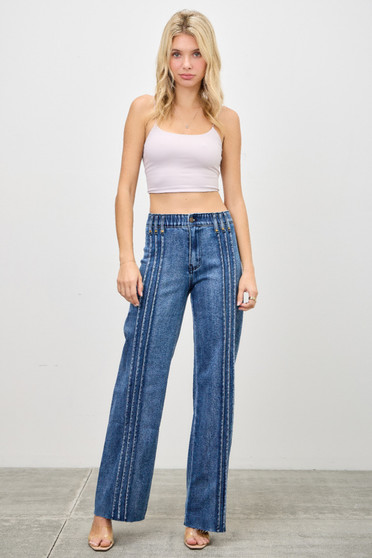 Model wearing high-waisted blue wide-leg jeans with unique vertical pintuck seams, a gathered waistband, and raw hems paired with a light lavender crop top.