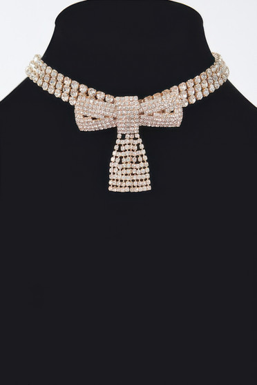 "A sparkling crystal bow choker necklace featuring three rows of brilliant rhinestones and a central pavé-set bow with a shimmering crystal tassel pendant, displayed on a black mannequin bust."