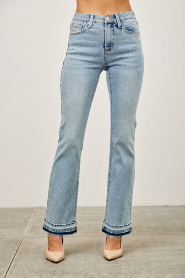 Front view of women's light wash high-rise flare jeans with a unique released shadow hem.
