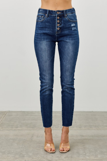 High-rise skinny jeans in a dark wash featuring an exposed button fly and raw hems.
