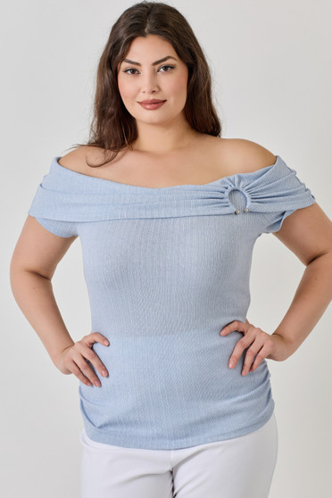 Woman wearing a light blue off-the-shoulder ribbed top with silver ring hardware detail.