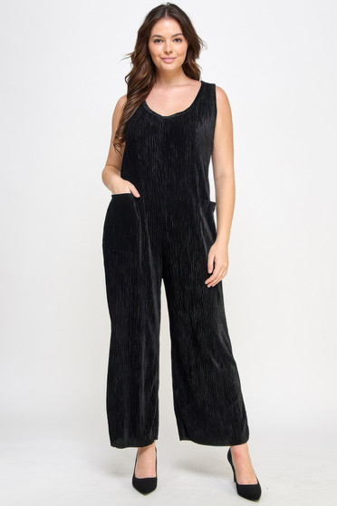 Elegant black wide-leg jumpsuit in a shimmering plissé fabric styled with black pointed-toe heels.