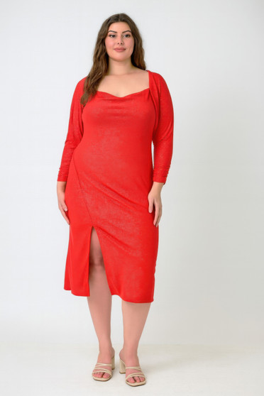 "Plus-size model wearing a two-piece shimmer red midi dress with a matching long-sleeve bolero shrug, featuring a cowl neckline and a high side slit against a white background."