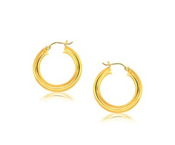 Classic hoop earrings in polished finish crafted in 14k yellow gold and measuring 30 millimeters in diameter. Secured with a snap lock backing.