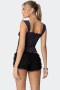 Polka dot bustier top featuring a square neckline with delicate black lace trim and a small center bow.