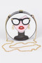 A circular hard-shell white clutch featuring a pop-art illustration of a woman with black cat-eye glasses, red lipstick, and a black turtleneck, complete with a gold chain strap.
