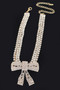 "Silver-tone crystal bow statement choker with hanging rhinestone fringe."