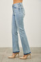Women's high-waisted flare jeans in light indigo wash featuring a double-layered released hem with raw fringe.