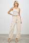 Full-length shot of stylish tan denim utility pants featuring wide cuffs and architectural stitching.