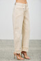 Cream utility jeans with architectural seams and oversized cuffs.
