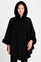 "Woman wearing a luxury black hooded poncho with plush faux fur trim on the hood and cuffs, featuring a draped silhouette and wool-blend fabric."