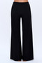 "Model showcasing floor-length black flare pants in a smooth, breathable fabric."