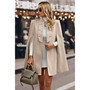 "Tailored blazer cape with padded shoulders and open sleeves for a professional office look."