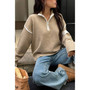 "Athleisure-inspired women's quarter-zip sweater with a structured collar and relaxed silhouette."