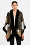 Women’s graphic knit cape with black faux-fur trim featuring abstract sunburst patterns in black, camel, and white.