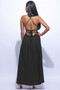 "Model showcasing a flowing black A-line maxi gown with thin halter straps and a side slit against a white background."