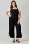Stylish black one-piece romper with wide legs and side-cinched detailing.
