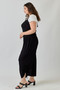 Boho-chic black wide-leg jumpsuit styled with black braided heel sandals.