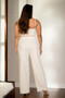Elegant monochrome ivory outfit with high-waisted trousers.