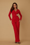 Woman posing in a sophisticated, fire-engine red evening jumpsuit with wide-leg pants and a flattering wrap-style top.