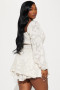 Long-sleeve cream smocked romper for special occasions and garden parties.