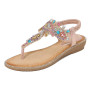 Bohemian-style flat sandals with a jeweled T-strap design, decorated with multi-colored teardrop gems and small crystals, worn on a model.