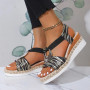 A pair of athletic-soled platform sandals worn with distressed denim jeans, showcasing a thick white traction outsole.