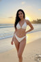 Women’s resort wear white crochet 4-piece swimwear ensemble.