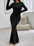 "Side-view of a floor-length mermaid gown emphasizing the sleek long sleeves and flared bottom."