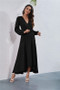 Woman in long-sleeve wrap maxi dress with V-neckline.