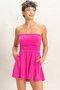 Vibrant pink strapless romper with ruched bodice.