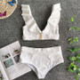 Premium textured white swimwear for women showing a ruffled plunge bikini top and flattering tummy-control high-waist bottoms.