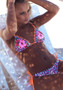 Tropical floral and leopard print string bikini with bright orange laser-cut scalloped detailing.