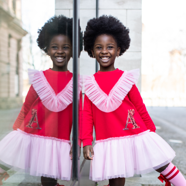 child in red and pink outfit