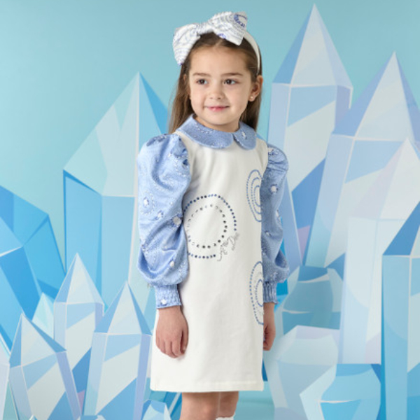 child in white dress with blue shirt