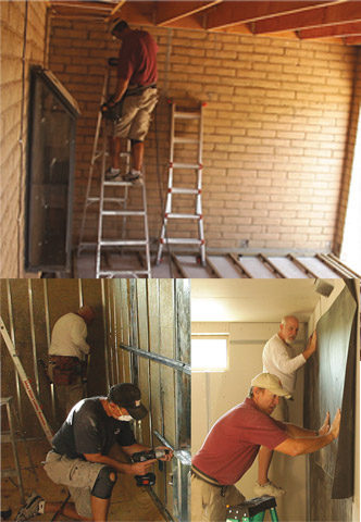 Workers installing wall panels