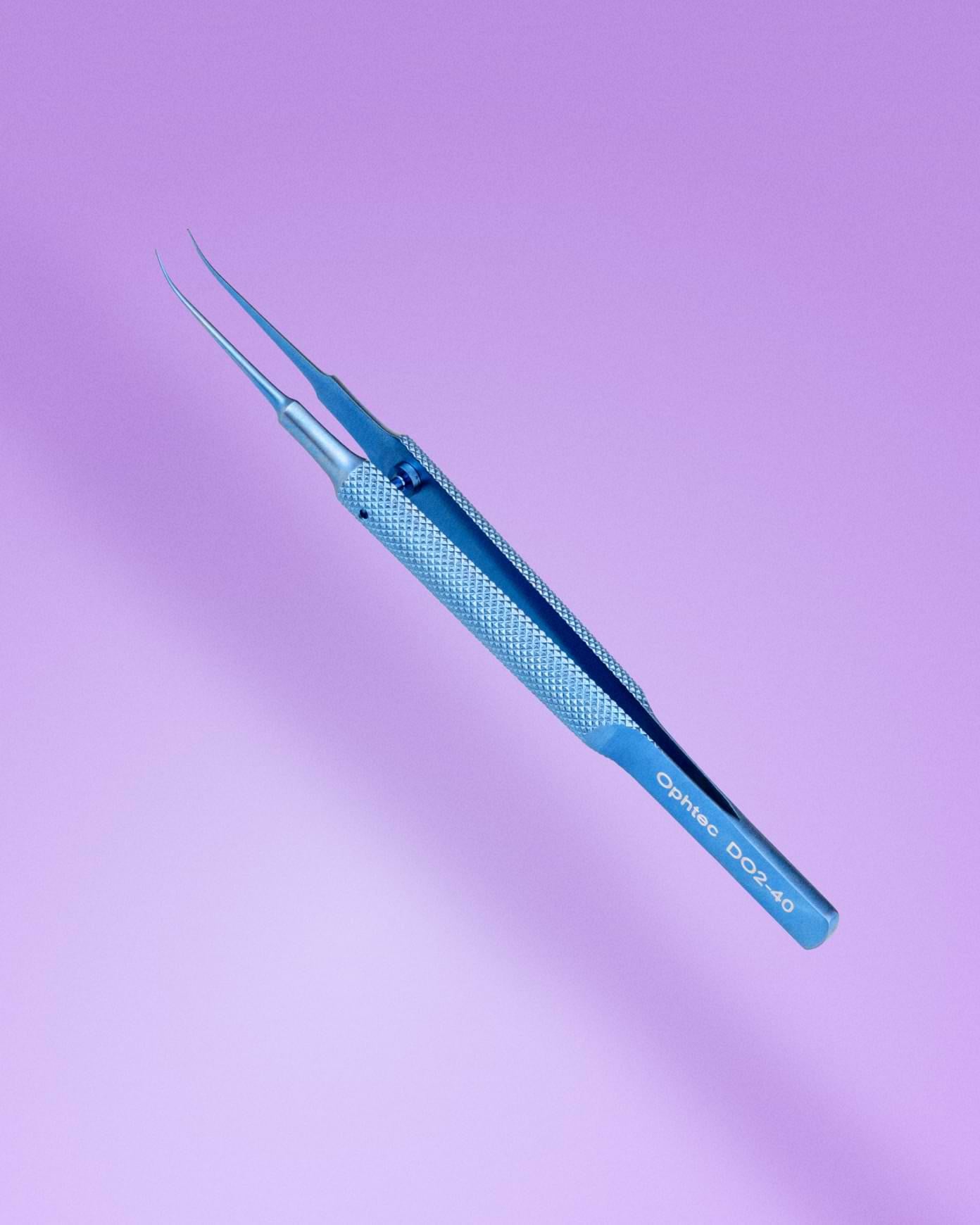 Artisan enclavation forceps close up on pink background