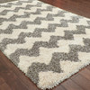 5' x 8' Grey and Ivory Geometric Shag Power Loom Polypropylene Area Rug