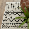 7' x 9' Ivory and Black Eclectic Patterns Indoor Area Rug