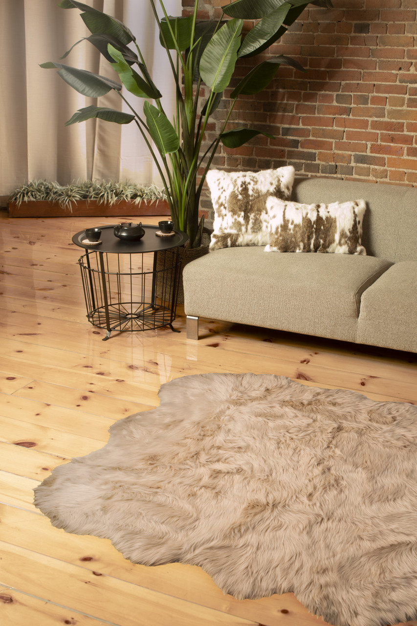 https://cdn11.bigcommerce.com/s-oo0gdojvjo/images/stencil/1280x1280/products/75374/109748/476648-5-x-6-taupe-faux-sheepskin-non-skid-area-rug__37741.1699148187.jpg?c=2