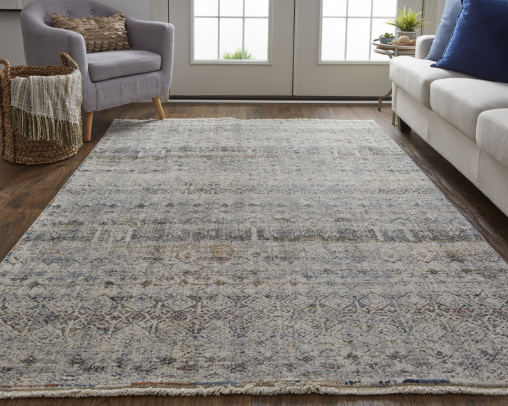 2' x 3' Tan Ivory and Blue Geometric Power Loom Distressed Area Rug with Fringe