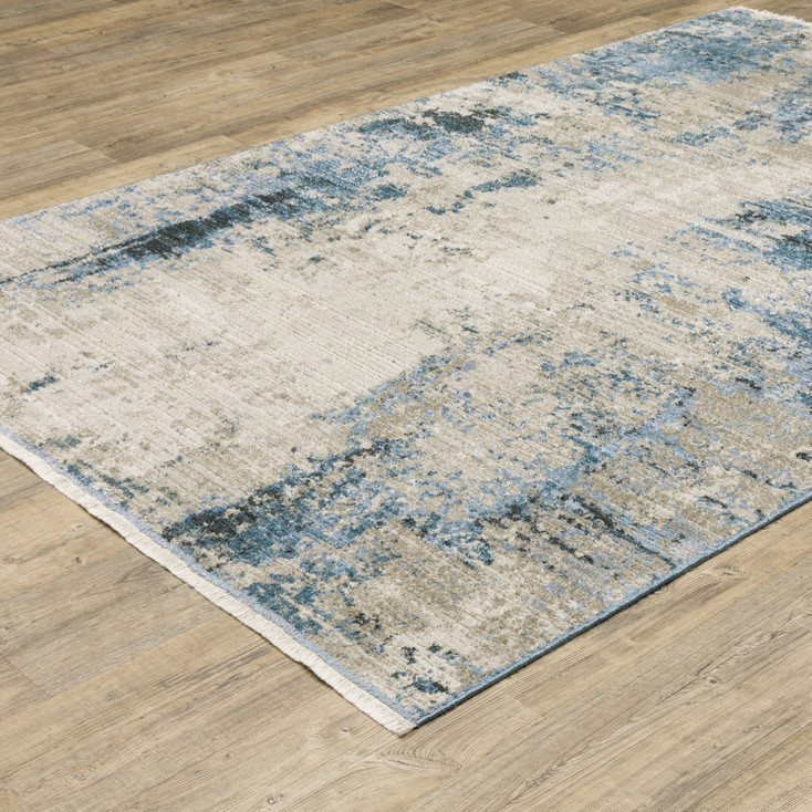 4' x 6' Blue Grey Ivory Light Blue and Dark Blue Abstract Power Loom Area Rug with Fringe