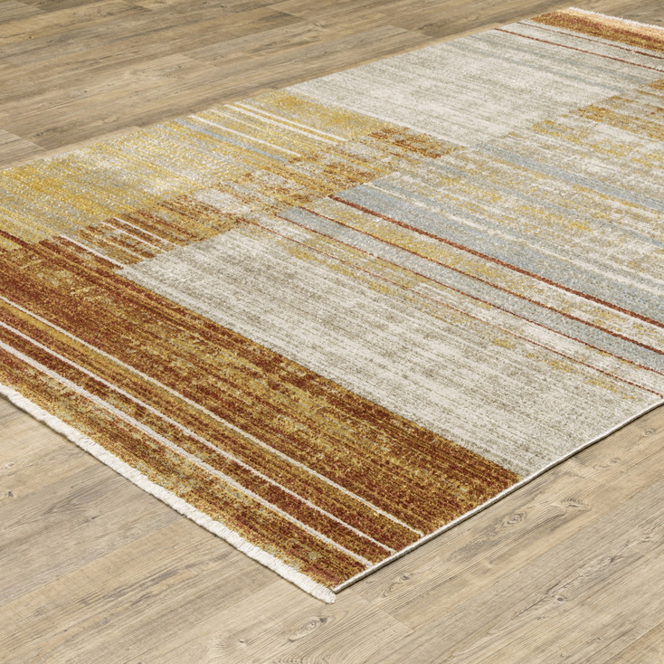 5' x 8' Rust Gold Blue Grey Ivory and Tan Geometric Power Loom Area Rug with Fringe