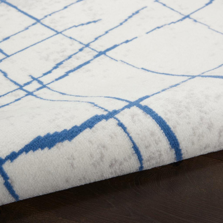6' x 9' Blue and Ivory Abstract Dhurrie Polypropylene Area Rug
