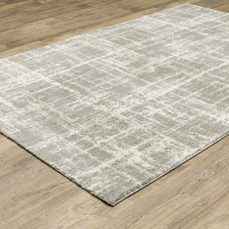 6' x 9' Grey and Ivory Abstract Shag Power Loom Stain Resistant Area Rug