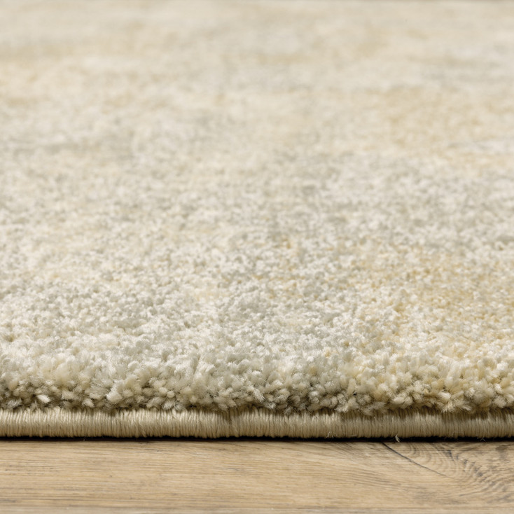 6' x 9' Grey Ivory Beige and Taupe Abstract Power Loom Stain Resistant Area Rug